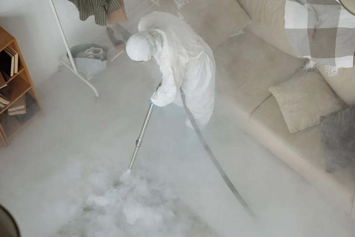 Biohazard cleanup technician in protective equipment, Three Rivers, OR
